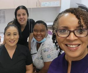 Dr. Harris with her Nurturing You Women's Health Team smiling