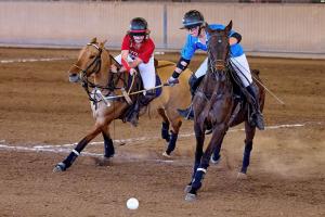two High School girls from Maryland and South Carolina mounted on horses play for the National Arena polo title