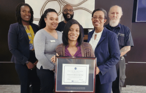 group photo of team at Courtyard High Point holding CAC framed certificate