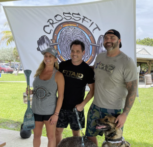 Kelli and Adam Davis, owners and Founders of CrossFit Sea Dog, with Warriors Choice Foundation Executive Director Anthony Longo and his service dog Bourbon.