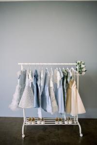 Flower girl dresses on a display rack.