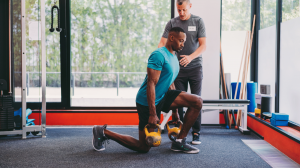 irvine personal trainer helping client lift kettlebells