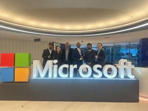 Total eBiz Solutions team members holding the award and smiling in recognition of their award as the Microsoft Asia Pacific Region Partner of the Year 2023 for Social Impact.