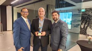 Total eBiz Solutions leaders holding the Microsoft Asia Pacific Region Partner of the Year 2023 for Social Impact trophy, demonstrating their dedication to utilizing technology for positive social change.