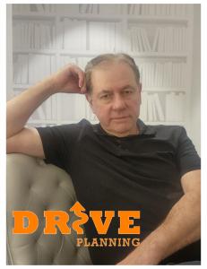 Terry Scott relaxed against white cushion chair with Drive Planning Logo in forfront