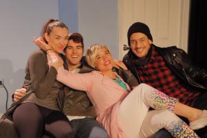 The photograph shows the cast, Maren Rosenberg, Whitman Johnson, Cat Hermes, Kal Naga, sitting on the couch on the set of Decolonizing Sarah, celebrating the opening night.