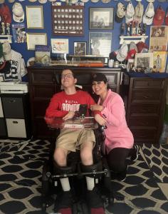 LuzElena Rivers of Amera and the Rivers for Health Foundation with Gary Lynn in his motorized wheelchair.