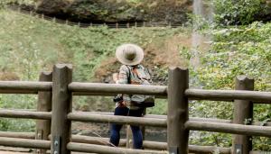 hiker enjoying the Valley viewing a waterfall