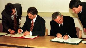 Image depicts the signing of the Good Friday Agreement