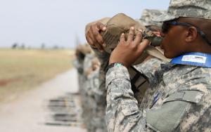 US soldiers drinking water from reusable canteens.