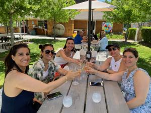 Women enjoying a wine tasting at a Long Island vineyard