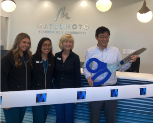 Matsumoto Team cutting a ribbon for new office