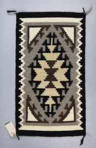 Vintage Two Grey Hills rug from Navajo weaver Alberta Henderson, 15 by 27 inches, with a geometric diamond pattern in grey, black tan and off white (est. $200-$2,000).
