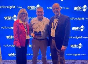 Joe Lauria, VP and COO of Shannon Global Energy (center) accepts the award from National Grid Program Managers Michelle Baker and Nathaniel Hancock.