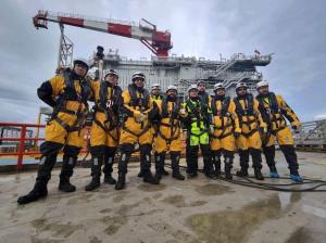 The maintenance team is seen waiting to board the vessel that will take it to the offshore wind farm