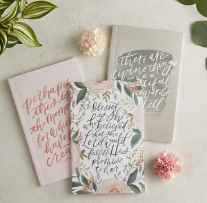 3 notebooks with different scripture verses on the covers