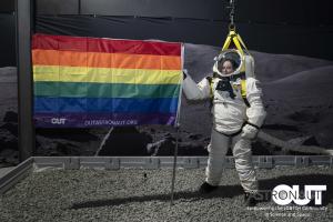 Out Astronaut member Brandy Nunez concludes an evaluation of a novel EVA space suit in simulated lunar gravity by planting an LGBTQ+ Pride Flag in the lunar regolith simulant. The flag serves to provide visibility and representation to LGBTQ+ individuals 