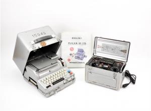 1960s Russian Fialka M-125 cipher machine with silver-painted case, integral keyboard and cover, silver-painted power supply unit and binder with English manual (est. $8,000-$12,000).