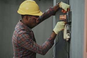 Male electrician doing electrical work.