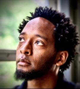 headshot of man looking up and to the left