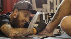 Tattoo Artist at Creates Design at Tattoo Expo