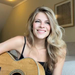 The artist Claire Marie and her Takamine guitar
