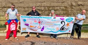 Turn the Tide festival, 29th May Dawlish. Team photo with our banner.