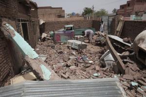 A man cleans debris of a house hit in recent fighting in Khartoum, Sudan, Tuesday, April 25, 2023.  Marwan Ali / AP