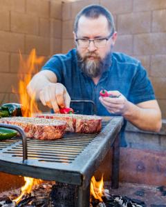 Author Brad Prose of Chiles and Smoke Grills up Steaks and Chiles