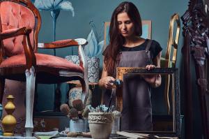 Female artist painting vintage picture frame photo