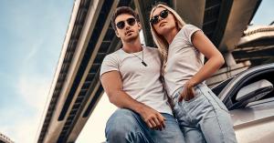 A man and a woman leaning against a car, wearing the 2023 Summer Collection from Jeans4you.shop