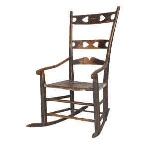 Mid-19th century Bellechasse rocking chair with the two upper back slats having heart cut-outs while the lower slat has a capucine profile, boasting a superb surface (est. CA$1,000-$1,500).
