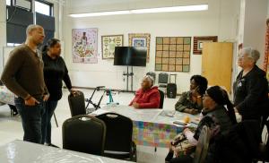 Man speaks to a tableful of older women