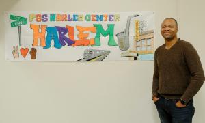 man stands in front of banner