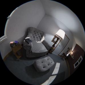 A still image of the fulldome film Grandmas house showing a couch and sofa sitting empty as the camera slowly floats through the room.