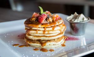 A stack of pancakes with fruit on top