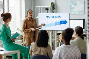 woman presenting marketing strategy to colleagues photo