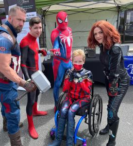 Image includes Treasure Valley Studio actors dressed as Captain Marvel (in wheelchair), Black Widow, 2 Spidermen, and Captain America holding Thor's Hammer