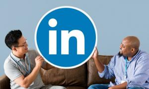 Two men holding the LinkedIn logo