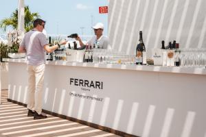 A white, outdoor serving station for sparkling wine