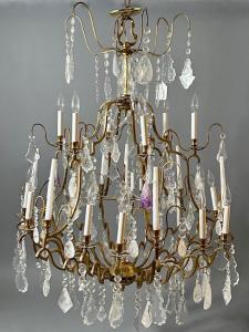 Large, modern Louis XV-style rock crystal chandelier, 12-light, 3-tiered form, with seven bobeche for candles (one in the center), 50 inches long by 38 inches wide (est. $2,000-$4,000).