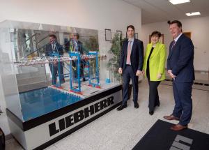 Photo of Ireland's Minister for Education, Minister Norma Foley TD at the Liebherr plant in Killarney, County Kerry with Charlie McCarthy of Liebherr (Left) and Professor Joe Walsh of Lero and MTU (Right).