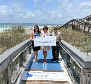 Representatives from the Florida State Parks Foundation, the St. Joe Community Foundation and Deer Lake State Park celebrate the purchase and installation of new mobility mats in the park.