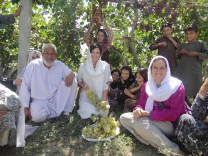 Image shows World Food Prize Laureate Heidi Kuhn sat amongst men and women with grapes as they undergo a training session
