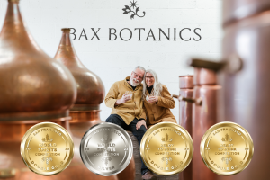 Chris and Rose Bax celebrating their medals in the Bax Botanics distillery