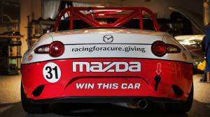 Back view of Red and White MX-5 Cup Car with words win this car written on back