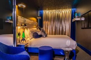 space-age design by artist and designer Henry Chebaane, retro-futuristic mood, Mathmos lava lamp, Scandinavian furniture, blue and silver interiors, in The Megaro hotel
