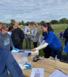 Mei Torrey helps out the Potomac Conservancy at an outdoor cleanup event