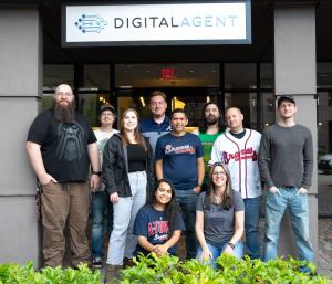 Group employee photo in front of Digital Agent sign.