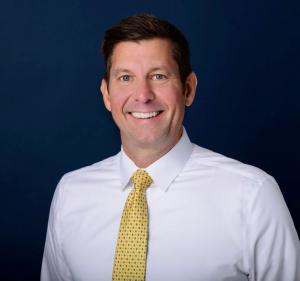 professional headshot of a smiling Arnie Stueber